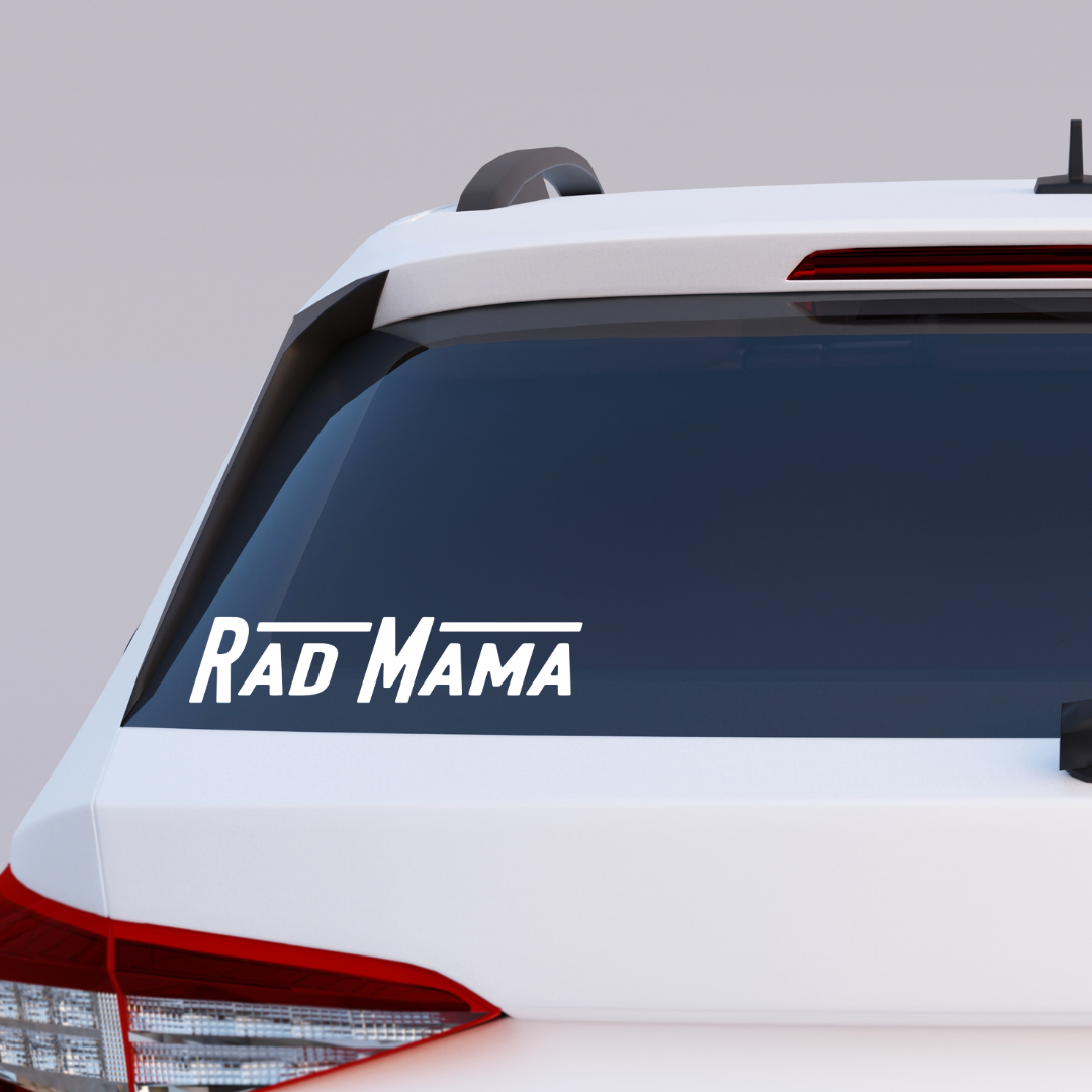 Rad Mama bumper sticker on the back window of a white car.