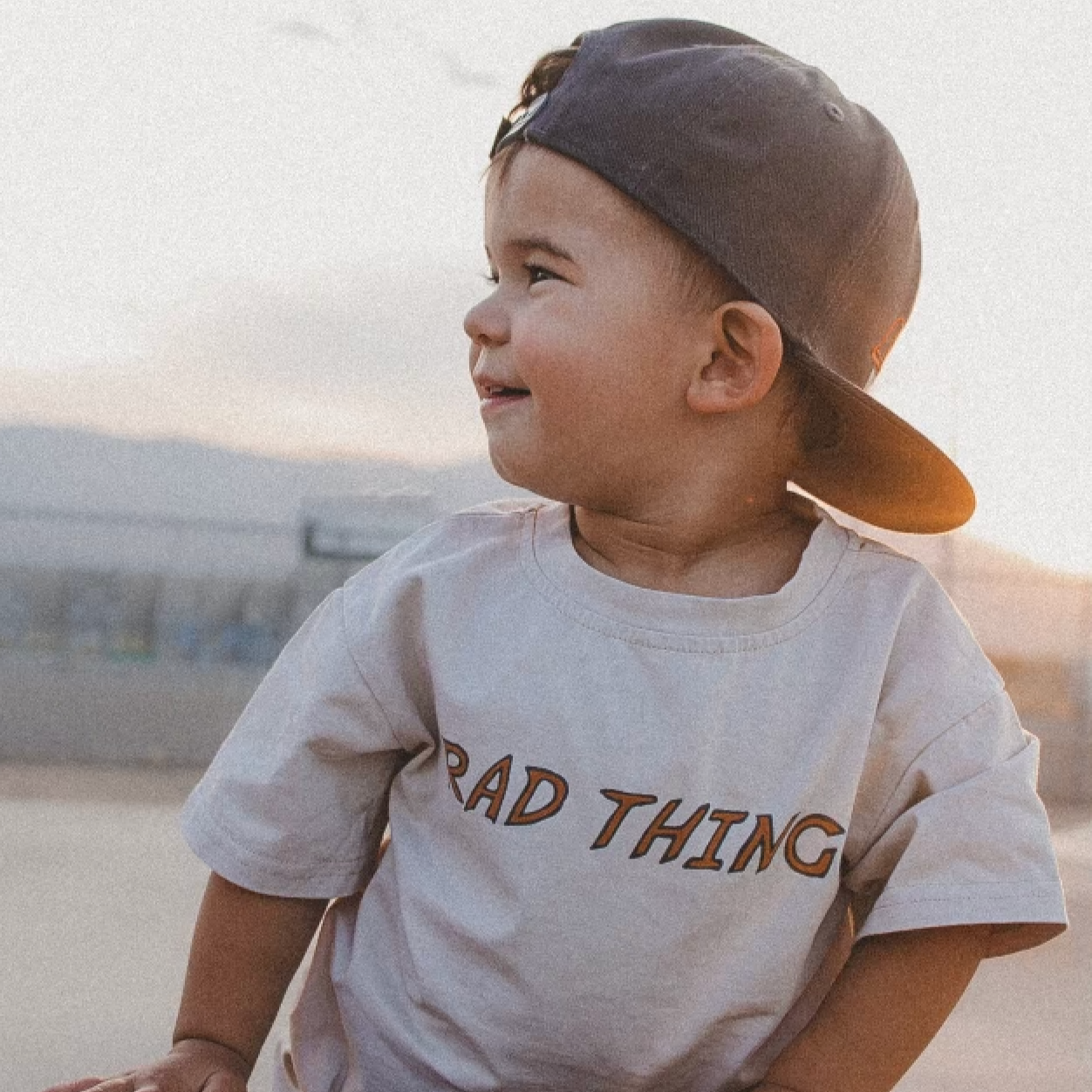 Toddler boy wearing 'Where the Rad Things Are' graphic tee.
