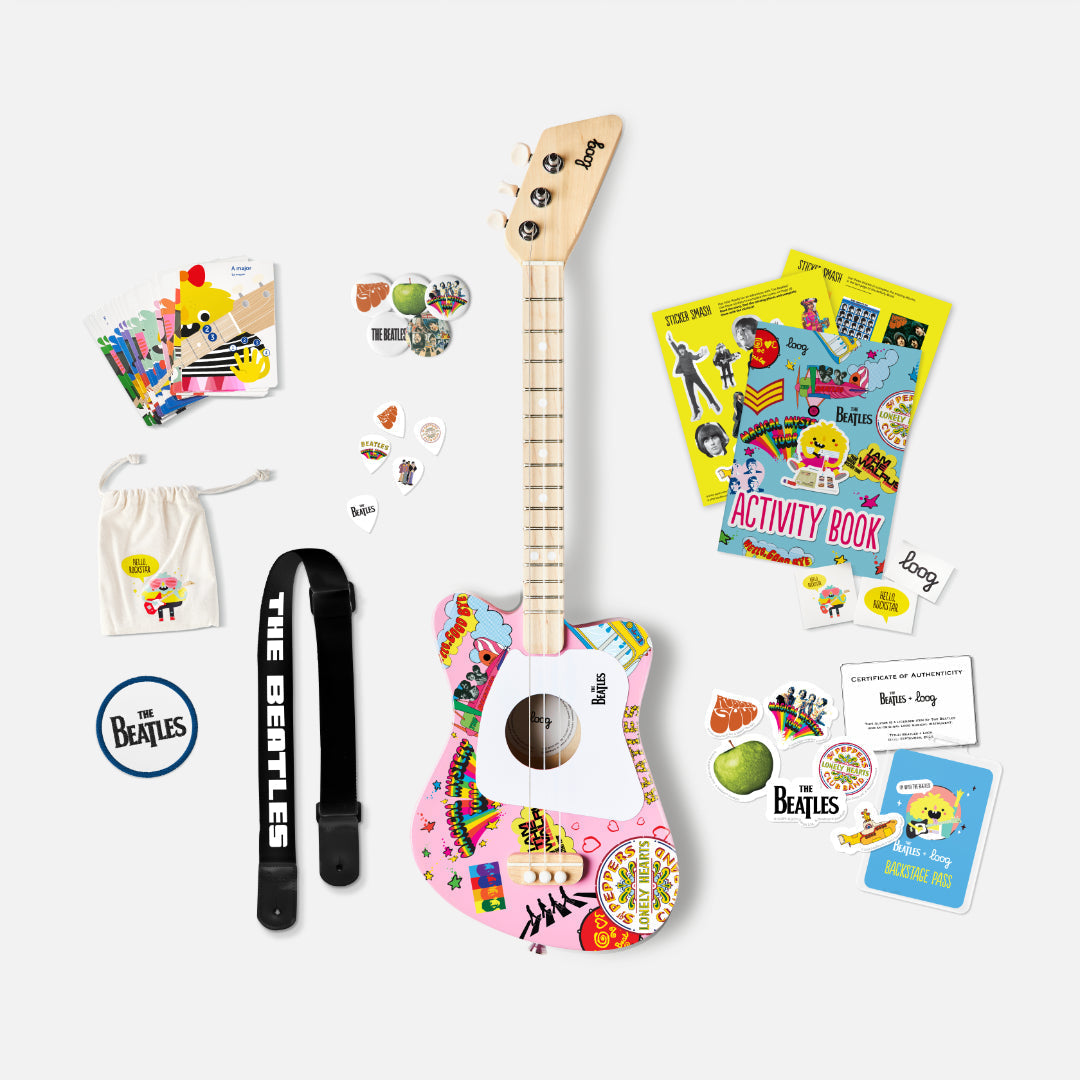 The Beatles Loog Mini Guitar bundle with strap, picks, activity book, and stickers.