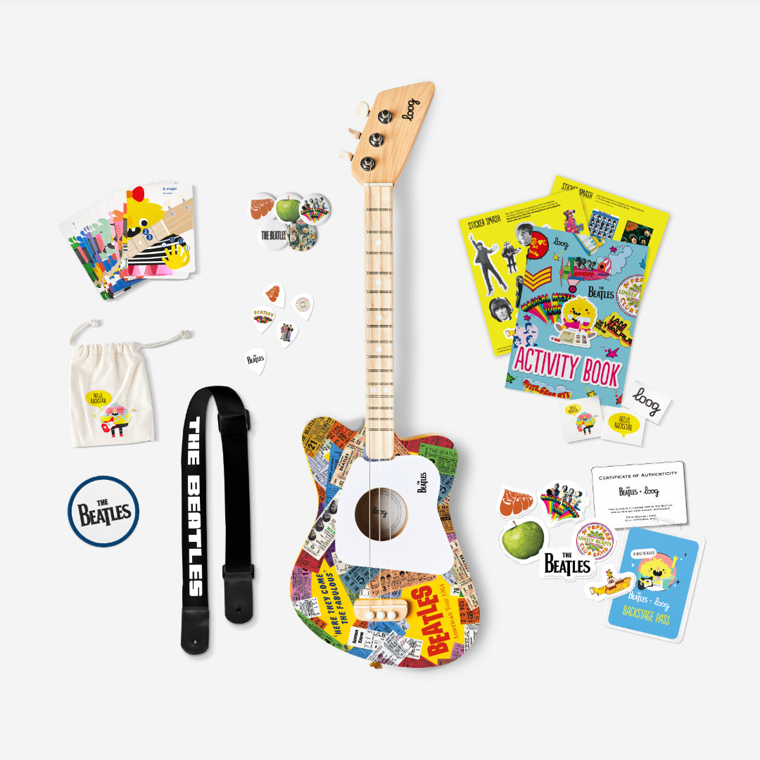 The Beatles Loog Mini Guitar bundle with strap, picks, stickers, and activity book.