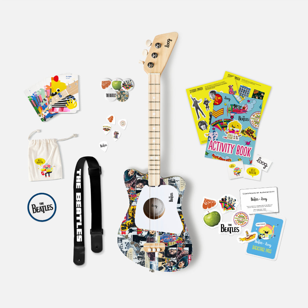 The Beatles Loog Mini Guitar complete set with strap, picks, activity book, and stickers.