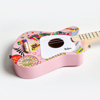 Angled view of pink Beatles Loog Mini Guitar showing details and Beatles logo.