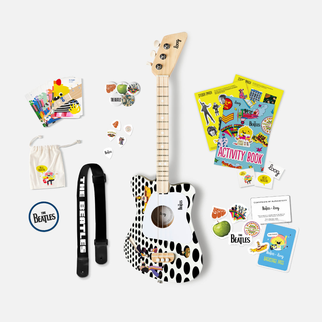 The Beatles Loog Mini guitar with strap, picks, activity book, and accessories