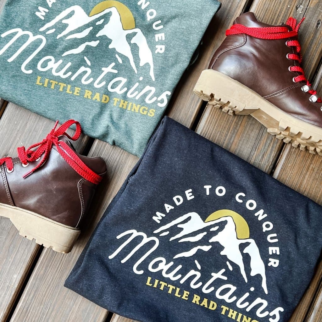 Two 'Made To Conquer Mountains' tees (green & black) with hiking boots