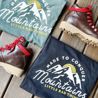 Two 'Made To Conquer Mountains' tees (green & black) with hiking boots