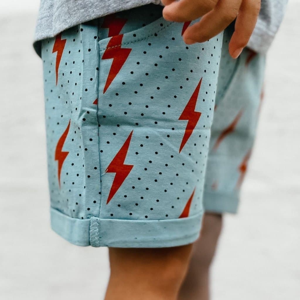 Spark Retro Shorts: Light blue with red lightning bolts and black polka dots.