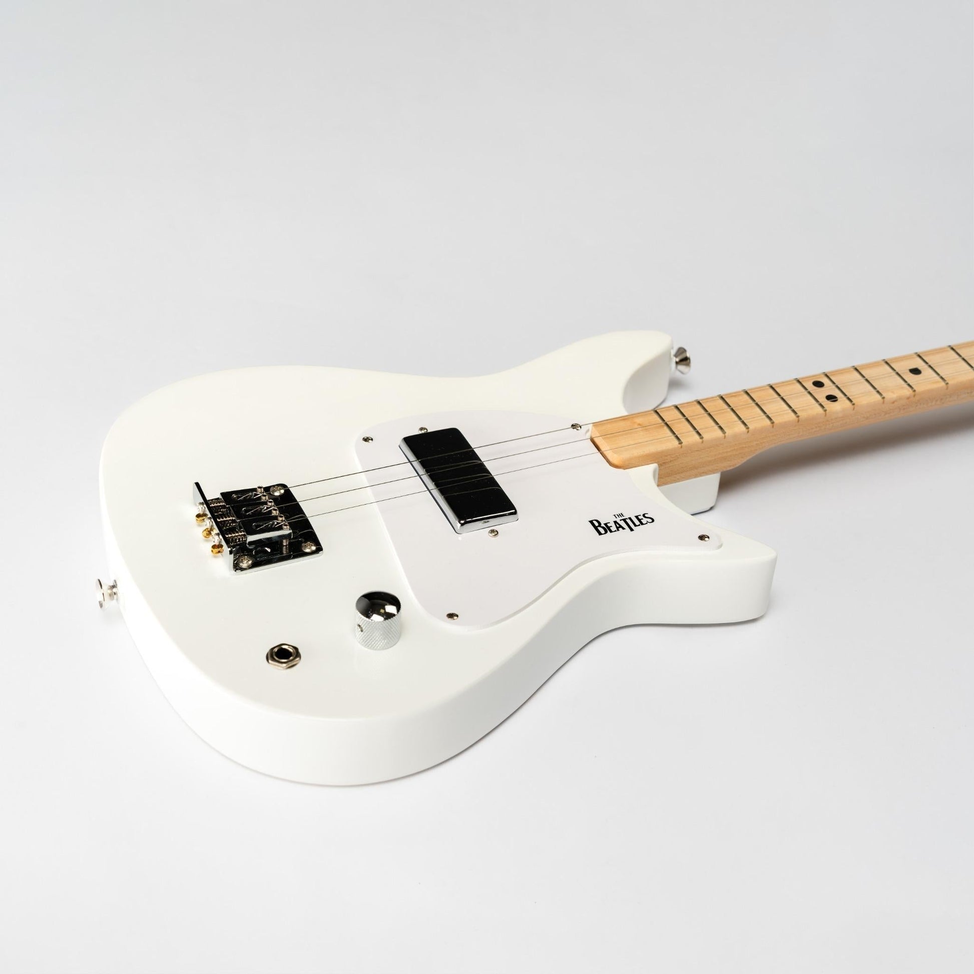 Close up of the white Beatles Loog 3-string electric guitar.