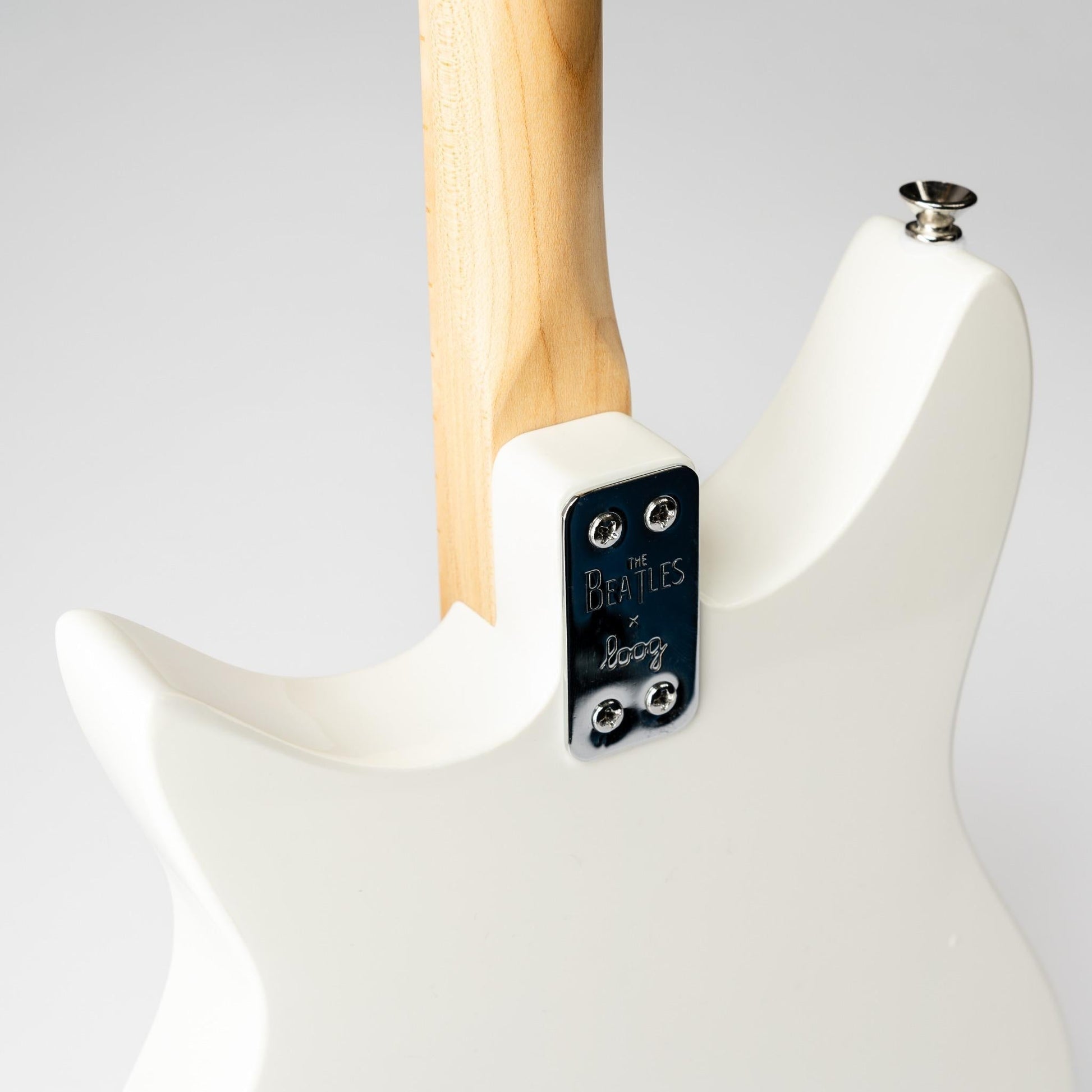 Close up of the body of white Beatles Loog 3-string electric guitar.