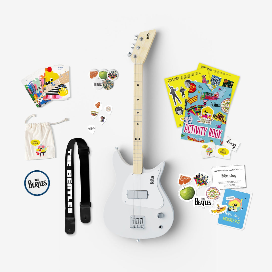 Beatles Loog electric guitar bundle with strap, picks, activity book, and stickers.